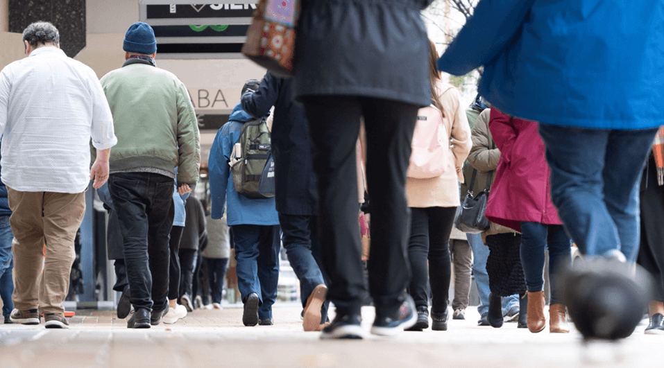 People shown from behind walking along a street