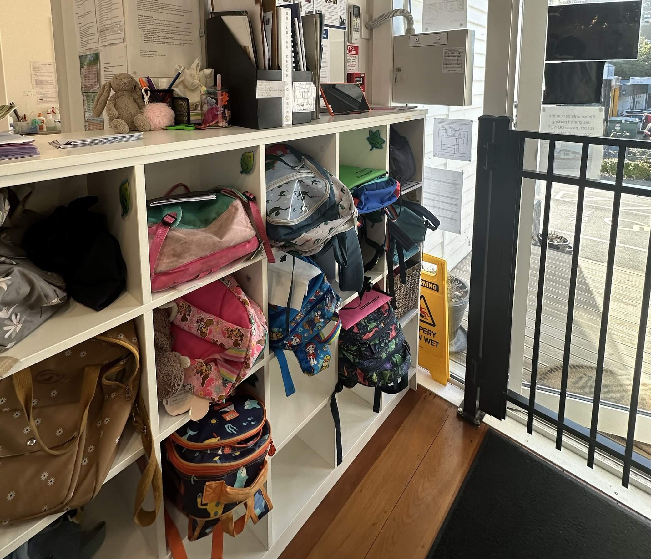 Children's backpacks stored in shelves