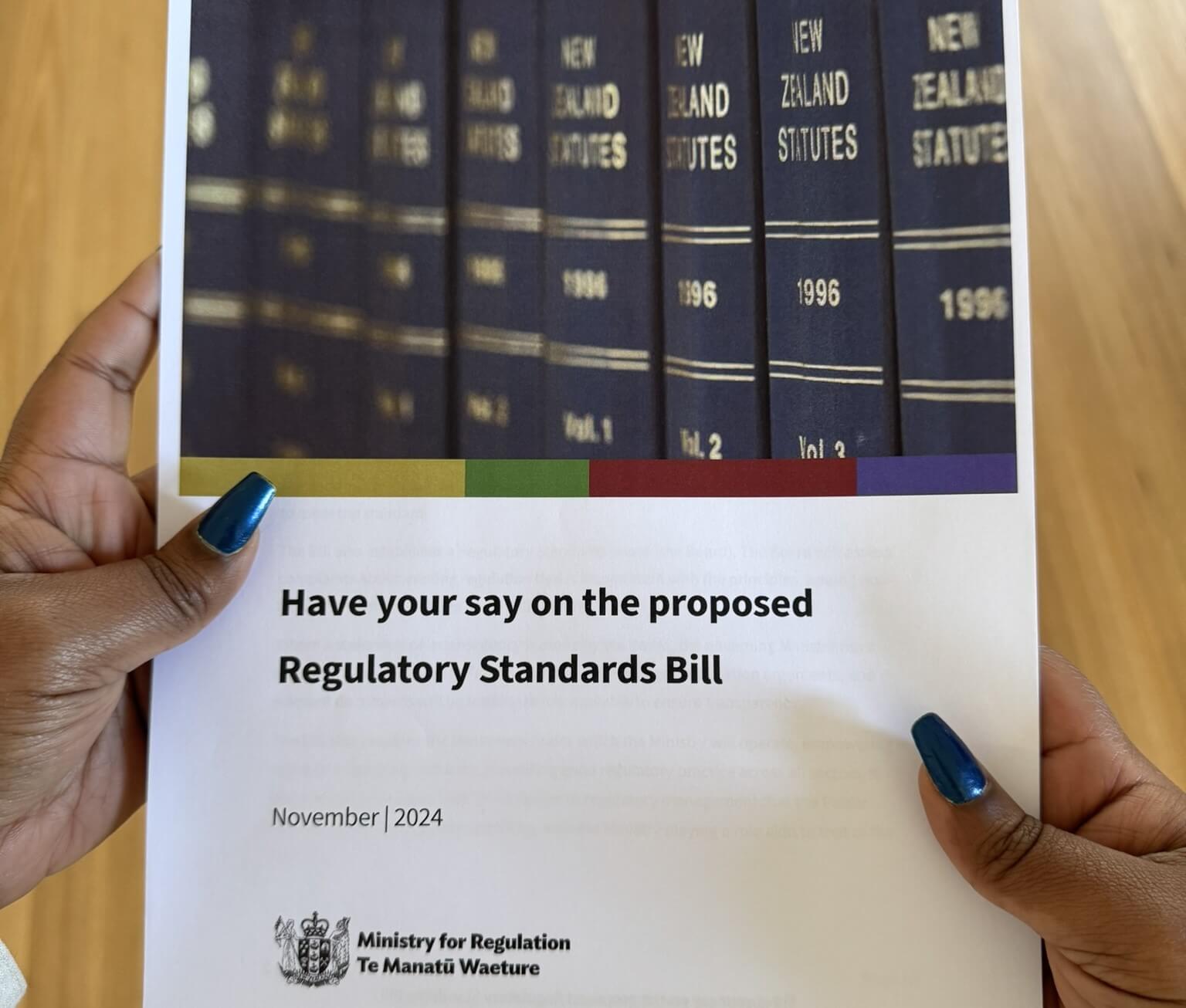 Hands holding a copy of the Regulatory Standards Bill document