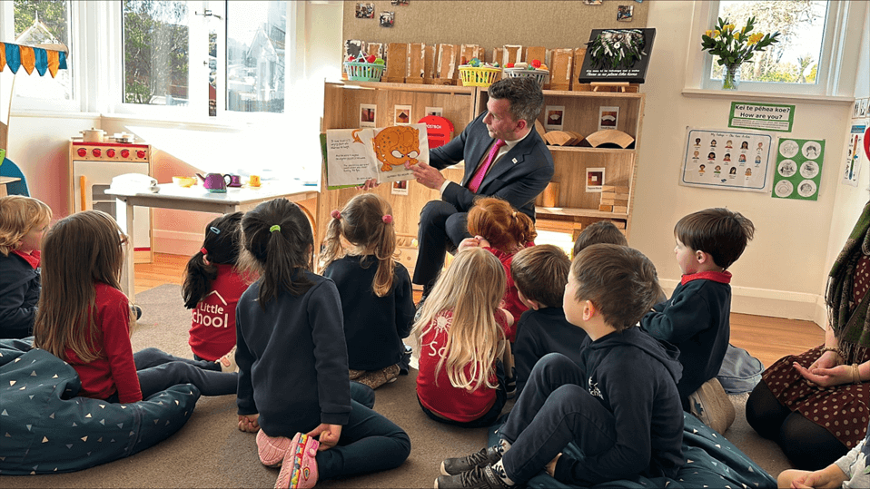 Small children in class listening to Hon David Seymour reading a book to them